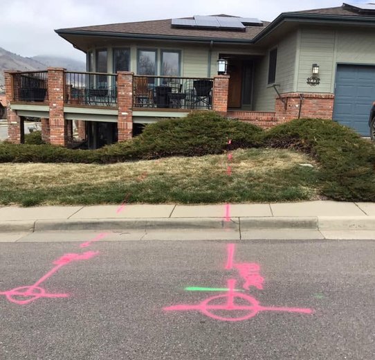 A residential house featuring a pink line on the ground, possibly marking a designated area or route
